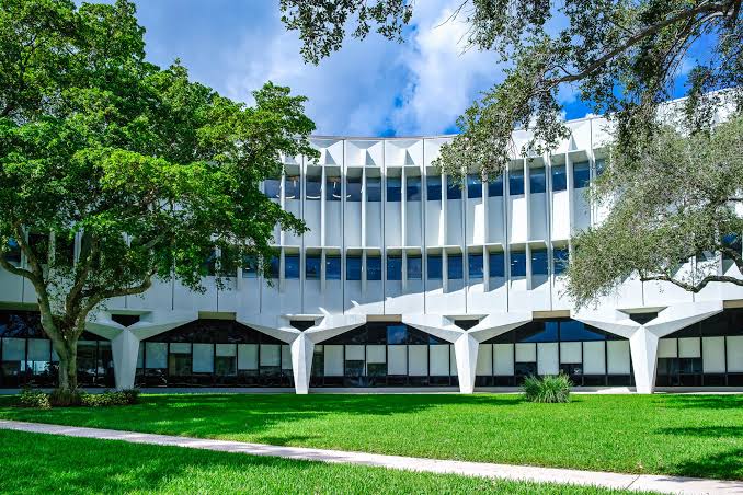 A photo of the Boca Raton Innovation Campus (BRiC). It is a Brutalist work of architecture with many tree-shaped columns on the ground level.
