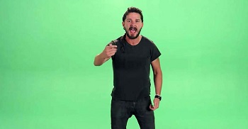 Screenshot of a video depicting the actor Shia LaBeouf yelling with a green screen behindhim.